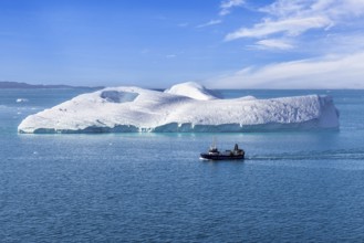 Iceberg seen from cruise ship vacation near Greenland coast in Arctic circle near Ilulissat Disko