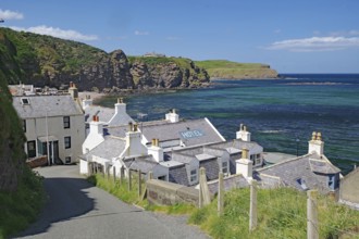 Village with hotel on coast with dramatic cliffs and blue water, Local Hero, Pennan, Aberdeenshire,