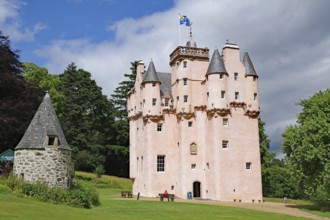 Pink castle with several towers under mostly blue sky, Craigievar Castle, Aberdeenshire, Scotland,