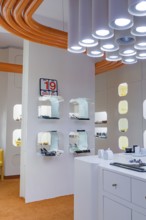 Futuristic interior with orange and white elements and unusual lighting design