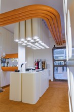 Contemporary kitchen with eye-catching white lighting and orange decoration