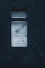 Close-up of a single set of syringes in blue packaging