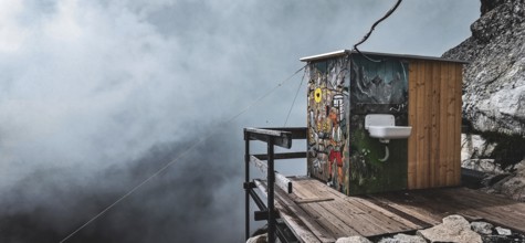 Colourful toilet at the Chata pod Rysmi mountain hut on a wooden platform in the middle of a