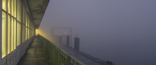 View along a long balcony of Steubenhöft of the ferry dock at Lübbenkai in fog, Cuxhaven, Lower