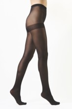 Unrecognizable woman walking on tiptoes in sheer butt lifting pantyhose isolated on white
