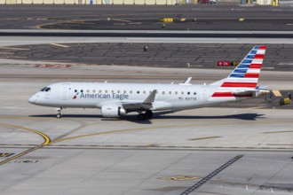An American Eagle Embraer 175 aircraft operated by Envoy Air with license plate N317TB at Phoenix