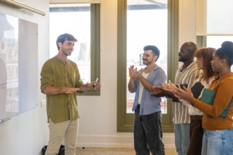 Diverse business colleagues showing appreciation for a successful presentation in a bright