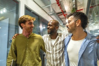 Diverse male colleagues walking together. Laughing and engaging in friendly conversation at a