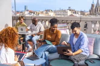 Group of diverse business people meeting and working together casually on a rooftop terrace,