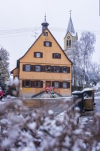 Historic building. Old town hall and church in the snow, typical traditional village architecture,