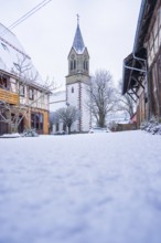 Historic church tower in a snowy village, quiet and rural winter atmosphere, Gechingen, Calw