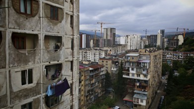 View of an urban landscape, residential district in Tbilisi with high-rise buildings and cranes,