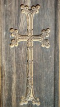 A detailed carved wooden cross on a wooden wall as decoration, Orthodox, Armenia