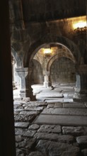 A stone, arched nave with an old, robust architectural design, Armenia