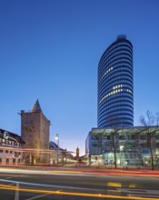 Johannistor and JenTower with light trails from cars at dusk, high-rise building, glass façade,