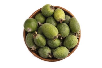 Ripe Feijoa in wooden bowl isolated on white background, top view, flat lay, close up, minimalism