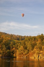 Hot air balloons over the Brno Reservoir (Brnenská prehrada) on the Svratka River on a sunny autumn