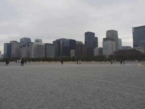 Cityscape with skyscrapers under a grey sky surrounded by a wide plain, Kokyo-gaien, Tokyo, Japan