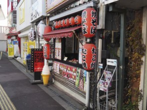 Small Japanese food stand with colorful lanterns on a street, Narita, Japan