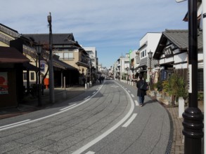 Empty street with traditional buildings and clear blue sky, Densha-michi street, Narita, Japan
