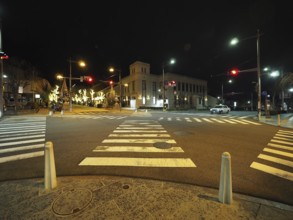 Night view of a quiet and illuminated city intersection with traffic lights, Chuo-dori street,