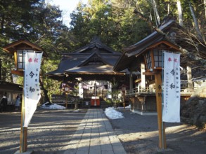 Traditional shrine surrounded by trees with wooden buildings and lanterns, Arakura Fuji