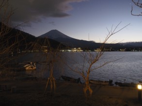View of lake at night with Mount Fuji in the background and calm atmosphere, Lake Kawaguchiko,