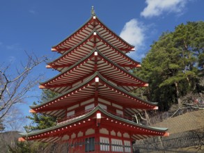 Chureito pagoda against blue sky surrounded by green trees, Kawaguchiko, Japan
