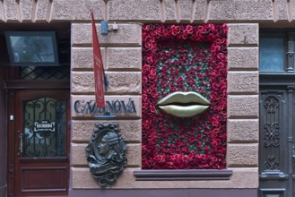 Bronze relief from Casanova, window with mouth and rose petals at Casanova restaurant, Lviv,