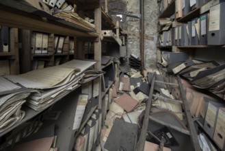 Shelves with dusty folders in the administration of a former GDR factory, Lost Place,