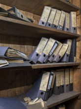 Shelves with dusty folders in the administration of a former GDR factory, Lost Place,