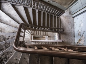 Staircase with wooden railing in a former sanatorium, Lost Place, Saxony-Anhalt, Germany