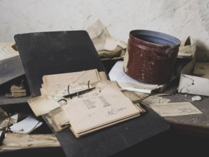 Folders, forms and an old pot on a table in a former GDR factory, Lost Place, Saxony-Anhalt,