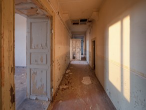 Corridor of an abandoned administration building in the light of the evening sun, Lost Place,