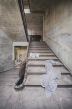 Staircase in a former children's recreation home in the GDR, curtains lie on the stairs, Lost