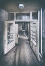 Double door, long corridor and open doors in a former sanatorium, Lost Place, Saxony-Anhalt,