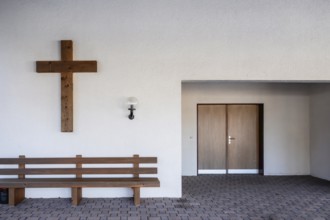 Church entrance and wooden cross, Zweisimmen, Switzerland