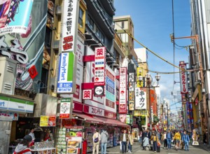 Lots of colorful signs in a pedestrian zone with shops and restaurants, Dotonbori, Osaka, Japan