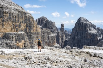 Hikers on the Sentiero Brentari hiking trail in front of cliffs, Brenta Mountains, Brenta-Adamello