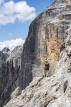 Hikers on the Sentiero Brentari via ferrata in front of cliffs, Brenta Mountains, Brenta-Adamello