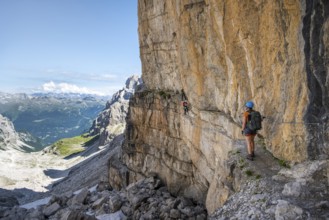 Mountaineers on the Bocchette Centrale band trail, via ferrata in the Brenta Mountains, rock wall,