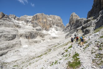 Hikers on hiking trail, behind Cima Margherita and Cima Tosa, Brenta Mountains, Brenta-Adamello