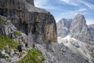 Three mountaineers on a hiking trail, rocky mountain landscape, Via Ferrata SOSAT via ferrata,