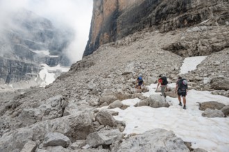 Hikers climbing via Ferrata Detassis, rocky mountain peaks and mountain landscape, Brenta