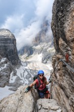 Climbers on the Via Ferrata Oliva Detassis via ferrata, rocky mountain peaks and mountain