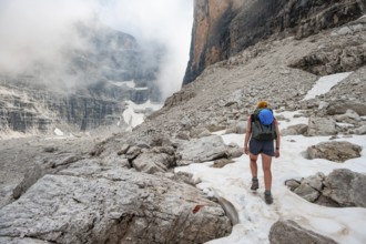 Female hiker climbing via Ferrata Detassis, rocky mountain peaks and mountain scenery, Brenta