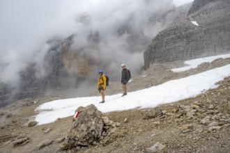 Mountaineers in a snowfield in fog, Brenta Mountains, Parco Naturale Brenta-Adamello, Trentino,