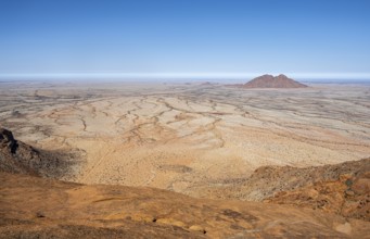 Wide desert landscape with rocky hills and bright blue sky in Spitzkoppe, Spitzkoppe, Namibia