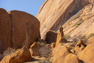 Elevated rock masses in warm tones under bright skies, Spitzkoppe, Namibia