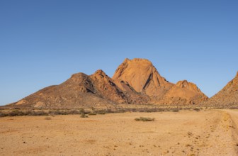 Wide desert landscape with distinctive orange mountains, Spitzkoppe, Namibia